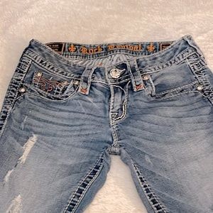 Rock Revival Alleen Skinny Jeans. Pink stitching. Made to look worn.